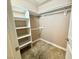 A walk-in closet with built-in shelving and carpeted floors provides ample storage space at 210 E Flamingo Rd # 215, Las Vegas, NV 89169