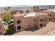 Aerial shot showcases community with multiple homes and covered parking with mountain backdrop in desert setting at 2200 Highpointe Dr # 202, Laughlin, NV 89029
