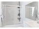 Bright bathroom featuring a glass-enclosed shower-tub combo, modern fixtures, and a large mirror at 2200 Highpointe Dr # 202, Laughlin, NV 89029
