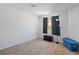 This bedroom has neutral walls, carpet floors, a window with curtains, and a blue storage bin at 2200 Highpointe Dr # 202, Laughlin, NV 89029