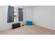 This bedroom has neutral walls, carpet floors, a window with curtains, and a blue storage bin at 2200 Highpointe Dr # 202, Laughlin, NV 89029