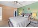 Comfortable bedroom features a large bed, a ceiling fan, and warm, neutral-toned walls at 2200 Highpointe Dr # 202, Laughlin, NV 89029