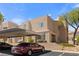 Multi-story building with desert landscaping, covered parking, and a visible red car at 2200 Highpointe Dr # 202, Laughlin, NV 89029
