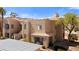 Exterior view of a desert home, showcasing its stucco facade, tiled roof, and well-maintained landscaping at 2200 Highpointe Dr # 202, Laughlin, NV 89029