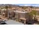 An elevated perspective highlighting the stucco exterior, desert landscaping, and common parking in this desert community at 2200 Highpointe Dr # 202, Laughlin, NV 89029