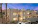 A tan stucco condo building has an attached covered parking area and desert landscaping at 2200 Highpointe Dr # 202, Laughlin, NV 89029