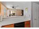 Eat-in kitchen with stainless steel dishwasher and view into a comfortable living space at 2200 Highpointe Dr # 202, Laughlin, NV 89029