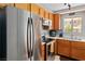 Well-lit kitchen features a stainless steel refrigerator and plenty of wood cabinets at 2200 Highpointe Dr # 202, Laughlin, NV 89029