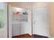 Convenient laundry area with washer, dryer, and storage shelving adjacent to front door at 2200 Highpointe Dr # 202, Laughlin, NV 89029