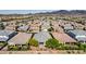 A vast neighborhood of single-story homes, each with unique roofing and landscaping, surrounded by mountains at 2433 Cingoli St, Henderson, NV 89044