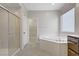 Bathroom showcasing a large soaking tub, and a separate glass-enclosed shower at 2433 Cingoli St, Henderson, NV 89044