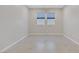 Bright bedroom featuring neutral walls, tile flooring, and windows with blue shades at 2433 Cingoli St, Henderson, NV 89044