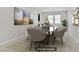 Virtually staged dining room features modern furniture and artwork for a stylish and inviting atmosphere at 2433 Cingoli St, Henderson, NV 89044