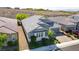 Aerial view of a gray single-story home with a well-manicured lawn and three-car garage at 2433 Cingoli St, Henderson, NV 89044