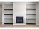 Built-in fireplace with open shelving on both sides offers a modern design element and ample storage space at 2433 Cingoli St, Henderson, NV 89044