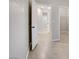 Open hallway featuring neutral walls, tile flooring, and white doors at 2433 Cingoli St, Henderson, NV 89044