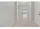 Bright hallway features an arched ceiling and tiled flooring, leading to the main living area and front door at 2433 Cingoli St, Henderson, NV 89044