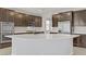 Modern kitchen featuring a large island with stainless appliances and granite countertops at 2433 Cingoli St, Henderson, NV 89044