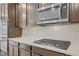 Modern kitchen featuring stainless appliances, stone countertops and dark cabinetry at 2433 Cingoli St, Henderson, NV 89044