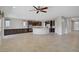 Open-concept living space features tile flooring, a large kitchen island, and dark wood cabinets for a modern feel at 2433 Cingoli St, Henderson, NV 89044