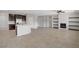 Spacious living room boasts a large island, stainless steel appliances, and a cozy fireplace with open shelving at 2433 Cingoli St, Henderson, NV 89044