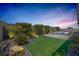 Lush backyard featuring well-manicured plants, a sparkling pool, and serene outdoor space at 2489 Cingoli St, Henderson, NV 89044