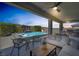 Luxurious outdoor living area with a pool, comfortable seating, and a built-in grill, perfect for entertaining at 2489 Cingoli St, Henderson, NV 89044