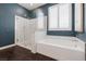 Modern bathroom featuring a glass-enclosed shower, soaking tub, and contemporary fixtures and fixtures at 2489 Cingoli St, Henderson, NV 89044