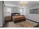 Comfortable bedroom featuring a queen-size bed, stylish nightstands, and large windows for natural light at 2489 Cingoli St, Henderson, NV 89044