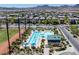 Community pool featuring a large swimming area, shaded seating, and well-maintained landscaping for resident enjoyment at 2489 Cingoli St, Henderson, NV 89044
