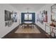 Stylish dining room boasts dark wood floors, a statement gallery wall, and a modern chandelier above the table at 2489 Cingoli St, Henderson, NV 89044