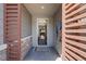 Inviting entryway with textured walls, wood slats, and stylish decor, offering a glimpse into the home's open layout at 2489 Cingoli St, Henderson, NV 89044
