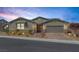 Charming single-story home boasts desert landscaping, a two-car garage and a neutral color palette at 2489 Cingoli St, Henderson, NV 89044