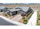 Single-story home featuring a brick driveway leading to an attached garage, complemented by professionally landscaped surroundings at 2489 Cingoli St, Henderson, NV 89044