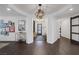 Elegant foyer featuring dark wood floors, modern light fixtures, and a curated gallery wall, setting a sophisticated tone at 2489 Cingoli St, Henderson, NV 89044