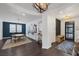 Spacious foyer featuring dark wood floors, modern light fixtures, gallery wall, and dining room at 2489 Cingoli St, Henderson, NV 89044