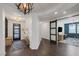 Stylish entryway with modern decor and seamlessly transitions to the adjacent living and office spaces at 2489 Cingoli St, Henderson, NV 89044
