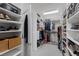 Spacious walk-in closet with custom shelves and clothing racks, providing ample storage space at 2489 Cingoli St, Henderson, NV 89044