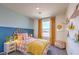Bright bedroom features a cozy bed, blue and cream colored walls, and nice curtains at 2534 Petunia Garden St # 222, North Las Vegas, NV 89081