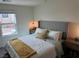 Comfortable bedroom with a large window, comfortable bed with pillows, and bedside tables at 2534 Petunia Garden St # 222, North Las Vegas, NV 89081