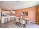 Bright dining area features an island kitchen with bar stool seating and modern decor at 2534 Petunia Garden St # 222, North Las Vegas, NV 89081