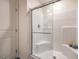Clean shower features bright white tiles and a glass door at 2534 Petunia Garden St # 222, North Las Vegas, NV 89081
