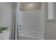 Clean white bathroom with a shower-tub combination and a neutral colored shower curtain at 2631 Chance Canyon St, Henderson, NV 89044