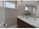 Modern bathroom featuring a double sink vanity with white countertops and neutral colored walls at 2631 Chance Canyon St, Henderson, NV 89044