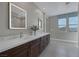 Modern bathroom with a double vanity, marble countertops, and contemporary mirrors at 2631 Chance Canyon St, Henderson, NV 89044