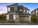 Modern two-story home featuring a gray exterior, attached garage, well-manicured landscaping, and a contemporary design at 2631 Chance Canyon St, Henderson, NV 89044