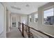 Bright hallway with carpet, wooden railing and multiple windows for ample natural light at 2631 Chance Canyon St, Henderson, NV 89044