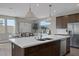 Modern kitchen island featuring stainless steel sink and dishwasher, adjacent to an inviting dining space at 2631 Chance Canyon St, Henderson, NV 89044