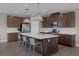 Modern kitchen with a large center island, stainless steel appliances, stylish pendant lights, and ample cabinet space at 2631 Chance Canyon St, Henderson, NV 89044