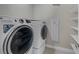 Convenient laundry room featuring front load washer and dryer units with built-in shelving at 2631 Chance Canyon St, Henderson, NV 89044